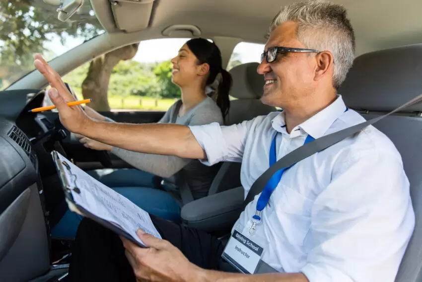 driving instructor is guiding student driving school in Gloucester