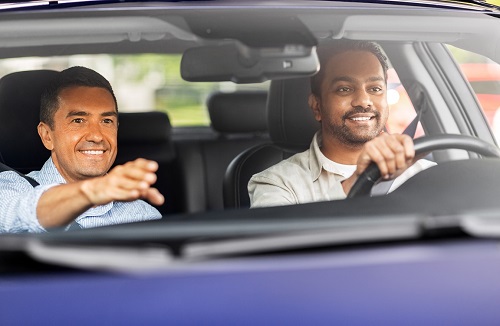 car driving school instructor teaching male driver